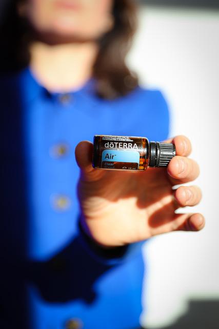 woman presenting a small bottle